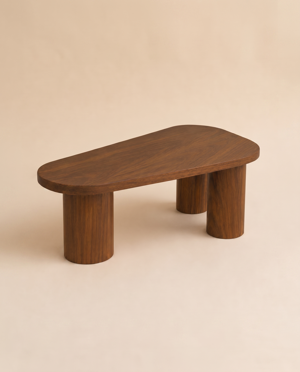 ORGANIC Coffee Table, a free-form solid walnut top on three turned legs, on a warm seamless backdrop